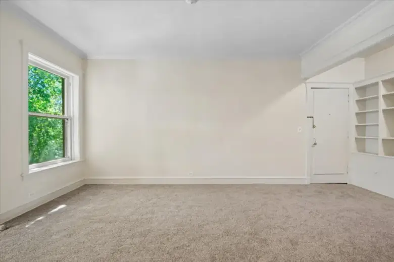 The same empty living room before staging