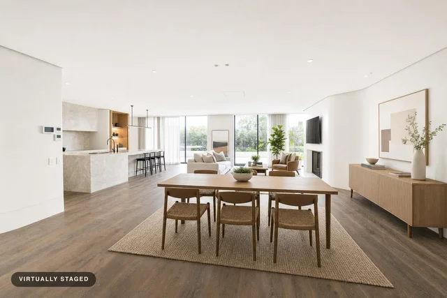 Open living and dining area with light wood furniture, large windows, and neutral decor in Scandinavian style.