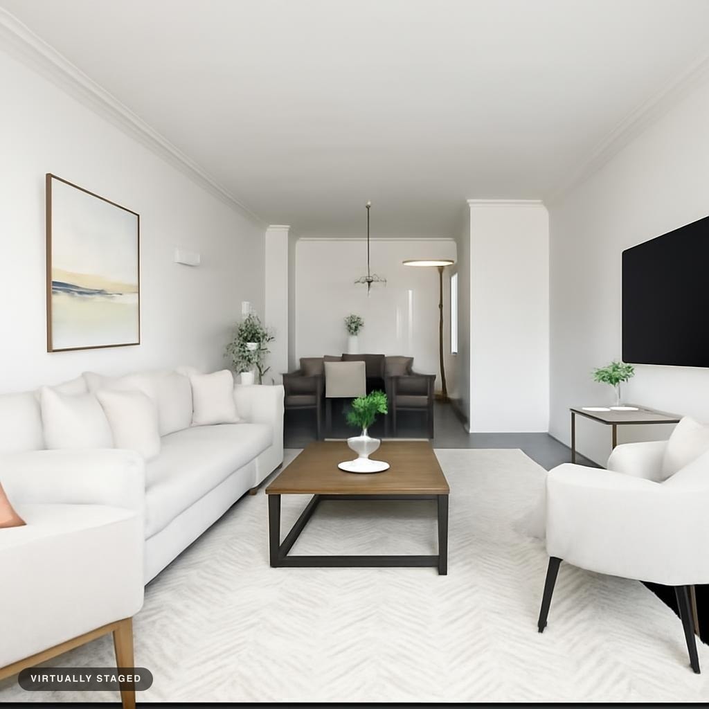 Modern living room with white sofa, armchairs, wooden coffee table, light rug, and abstract wall art.