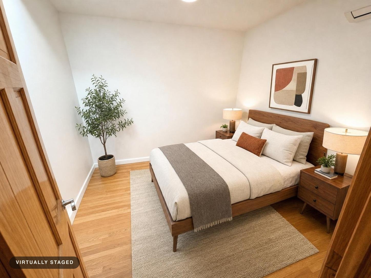 Midcentury style bedroom with wooden door, wood bed frame, beige bedding, two wooden nightstands with lamps, a small plant, and a potted tree.