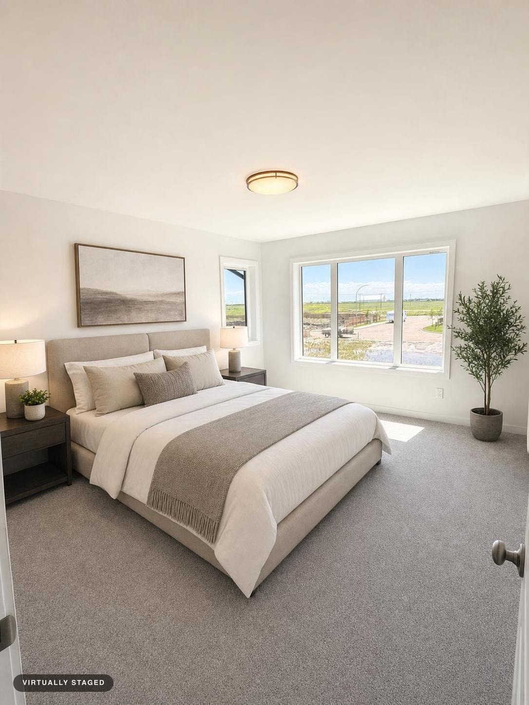 bright modern bedroom with a gray upholstered bed, neutral bedding, two dark wood nightstands with lamps, and a potted plant near the window