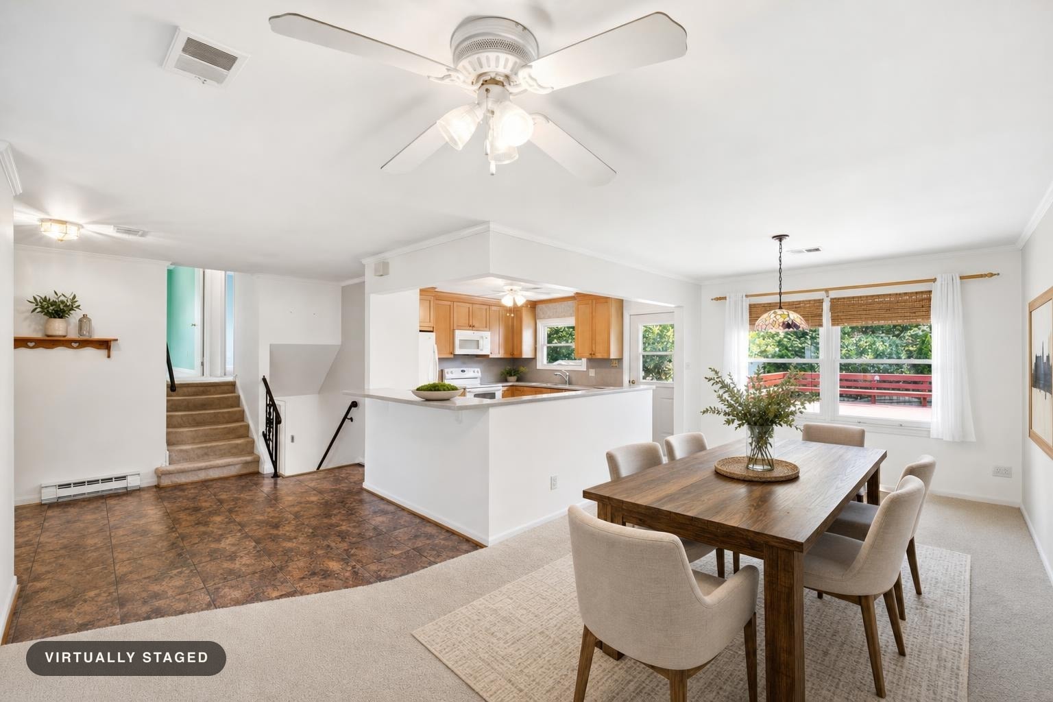 Modern dining room with a wood table, six beige upholstered chairs, white walls, woven window shades, and a pendant light above the table.