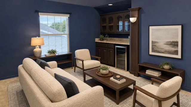 Living room with beige sofa and chairs, dark wood coffee table and shelves, blue walls, window, and framed wall art.