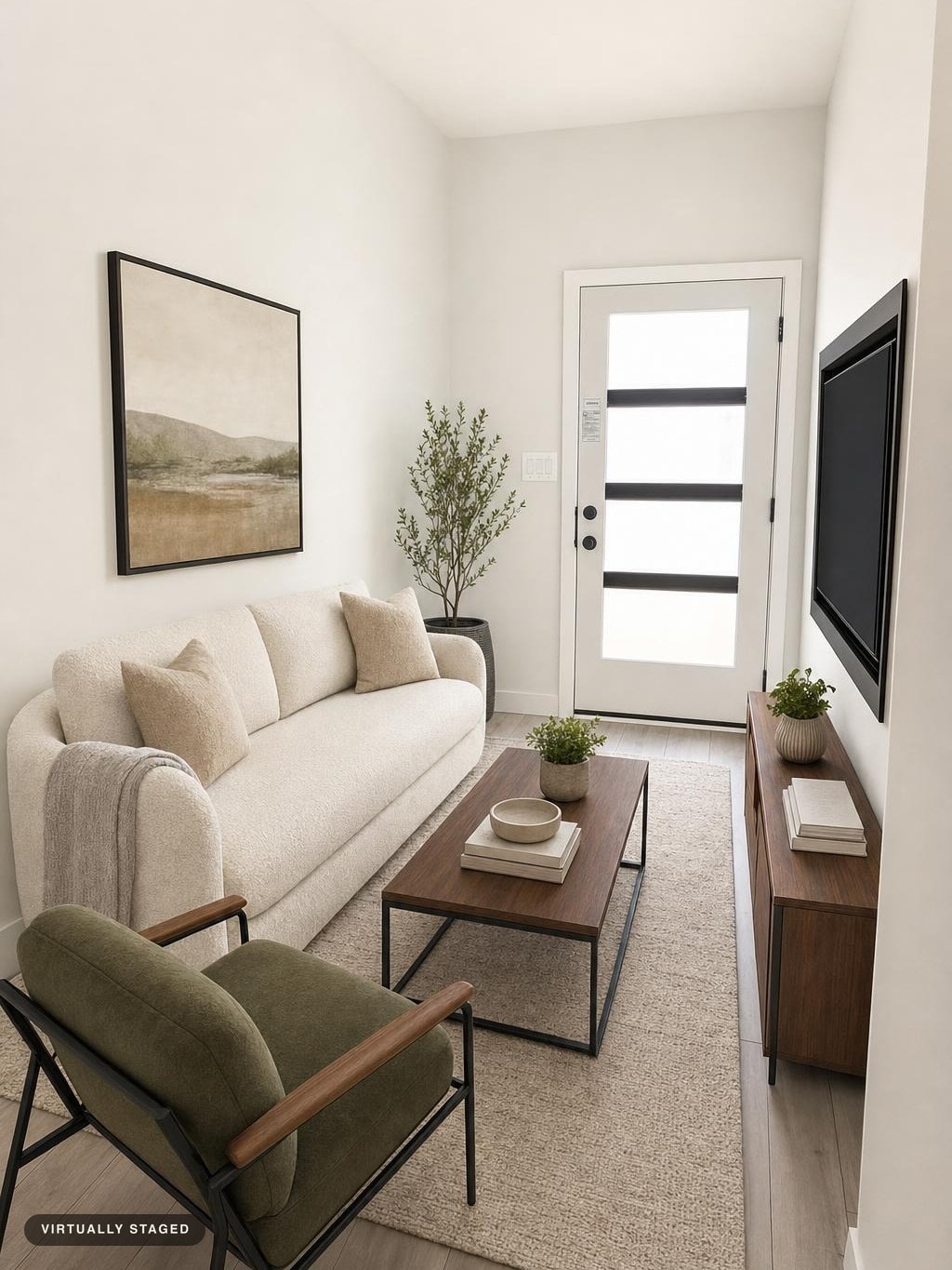 Modern living room with a cream sofa, green armchair, wooden coffee table, media console, and a white door with frosted glass panels.