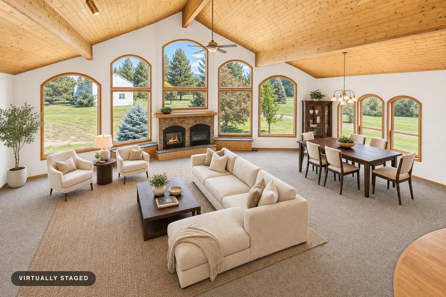 Spacious luxury living room with vaulted wooden ceiling, arched windows, beige sectional sofa, chairs, wooden coffee table, and dining area.