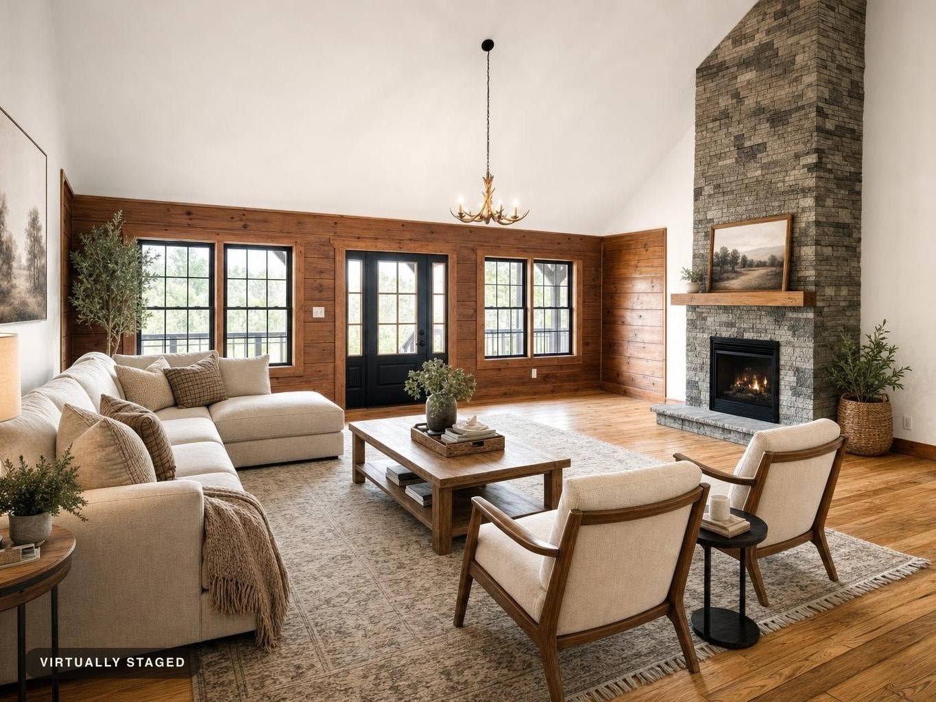 Living room with beige sectional sofa, wood-paneled walls, stone fireplace, wooden coffee table, and two beige armchairs.
