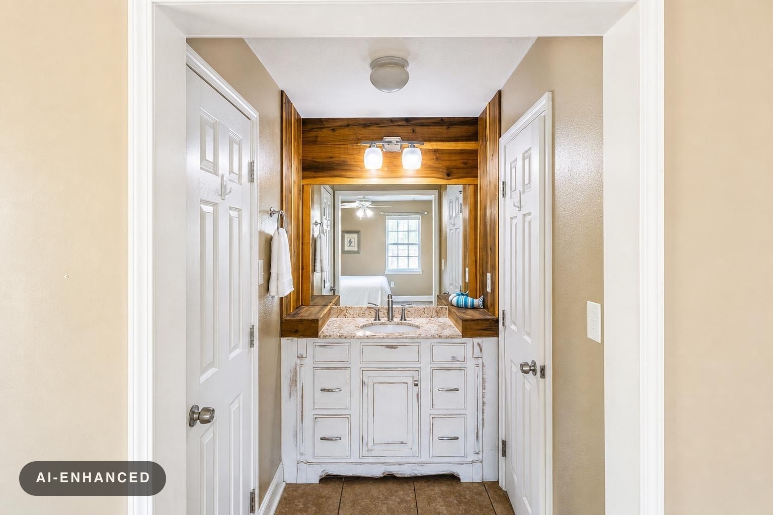 Rustic bathroom vanity with distressed white wood cabinet, granite countertop, wooden framed mirror, and two light bulbs above.